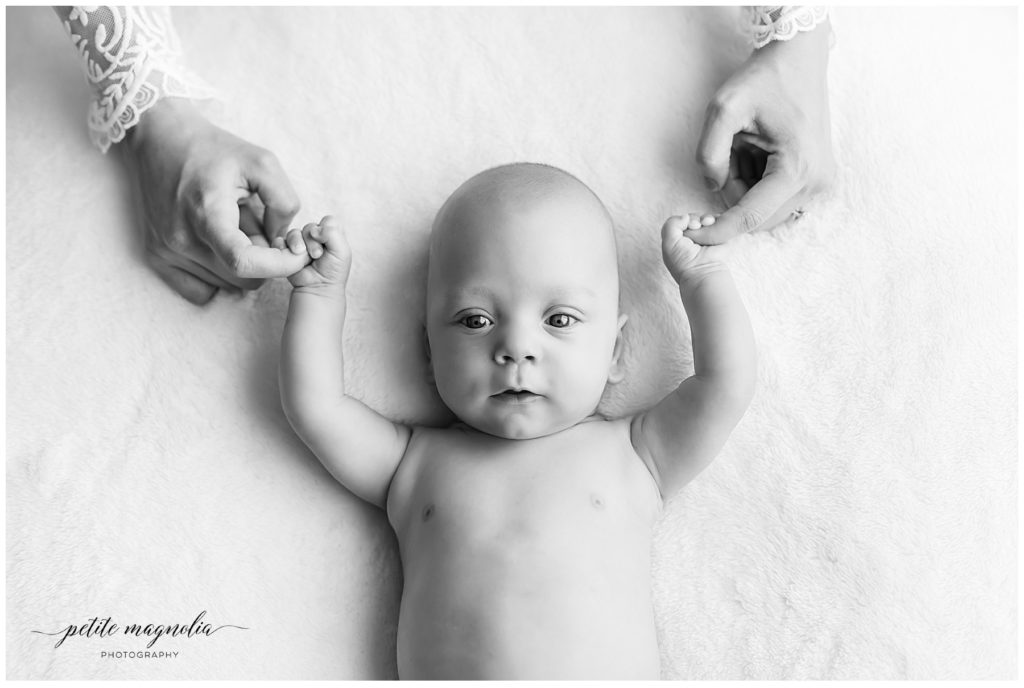 newborn session details newborn on bed holding mom's fingers , newborn photography pittsburgh 