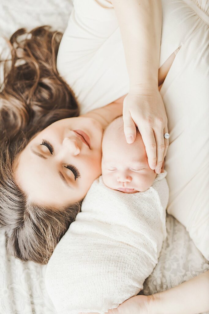 mother & newborn son laying on bed_petite magnolia photography