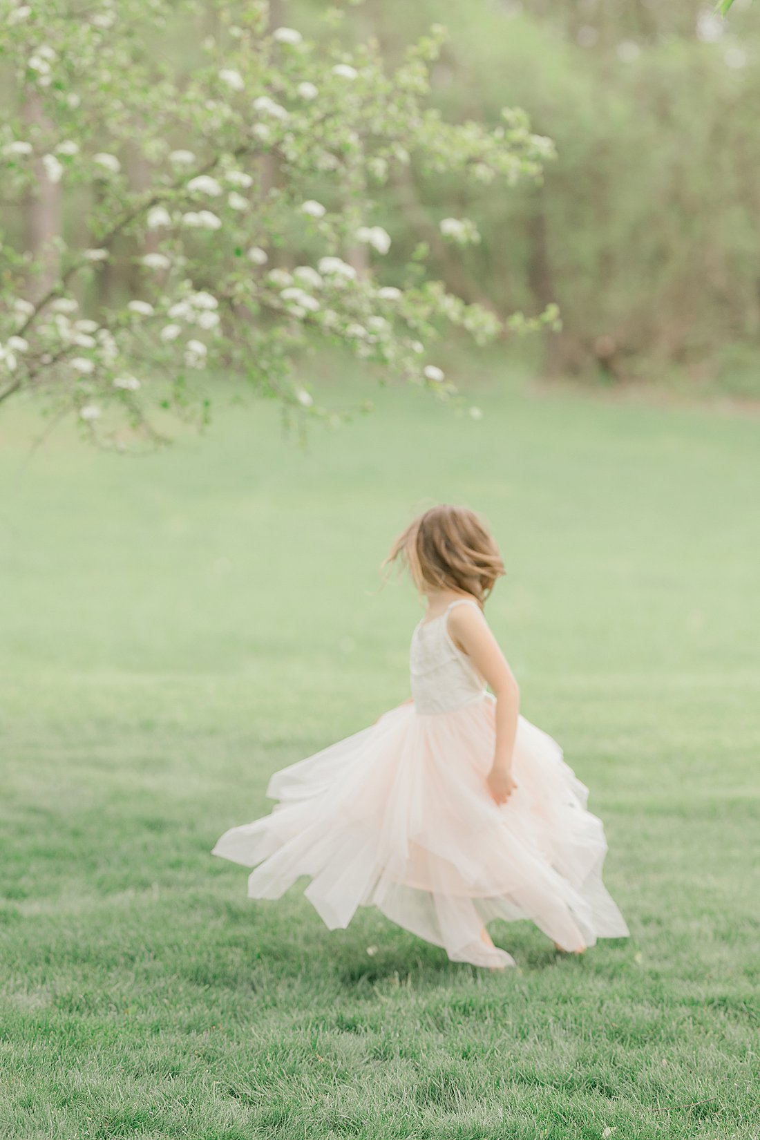 young Pittsburgh girl twirling during family pictures outdoors