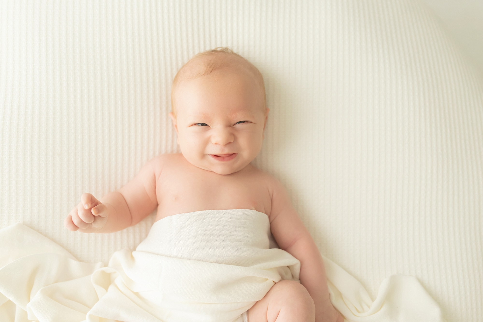 smiley baby during newborn photos in Pittsburgh photography studio