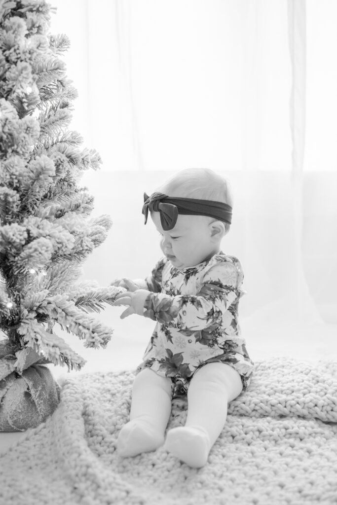 one year old Pittsburgh girl with christmas tree for first birthday photoshoot