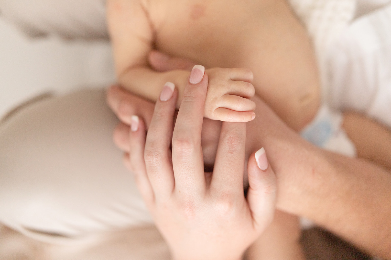 mom and dad hold their newborn's hand Breastfeeding Center of Pittsburgh