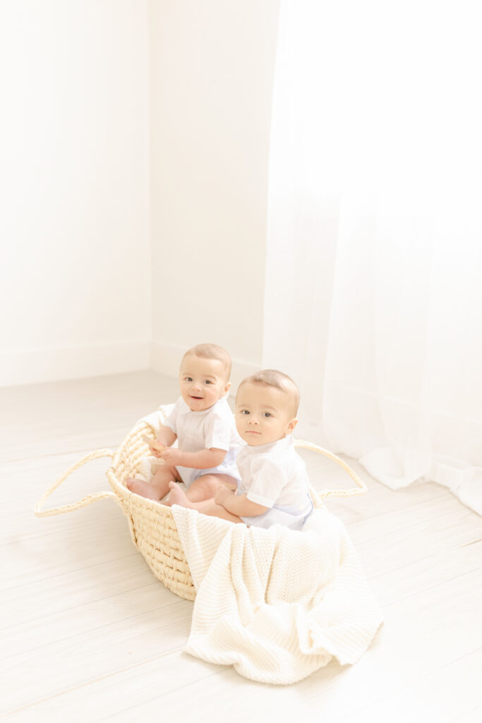twin boys sitting in moses basket photographed by pittsburgh child photographer petite magnolia photography